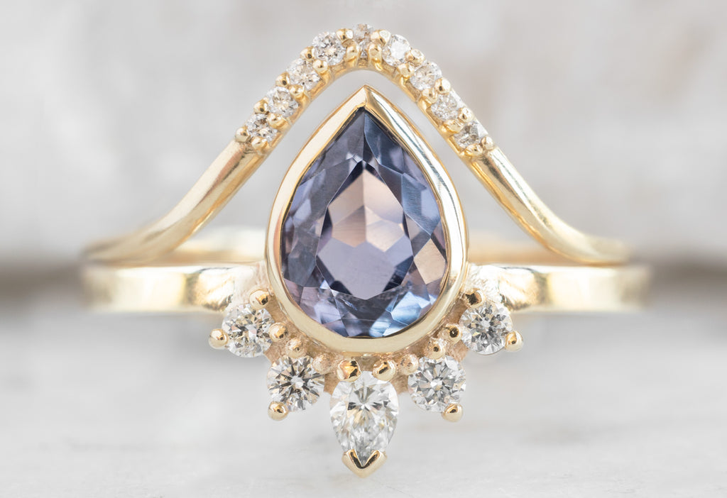 The Aster Ring with a Pear-Cut Violet Sapphire with Pavé Peak Band