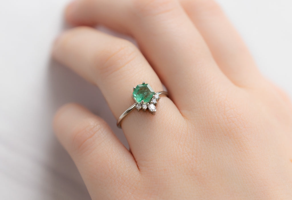The Aster Ring with an Emerald Hexagon on Model