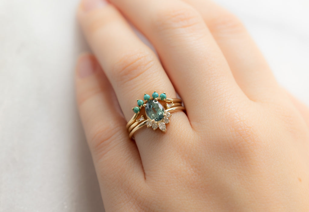 The Aster Ring with an Oval-Cut Montana Sapphire with Stacking Bands on Model