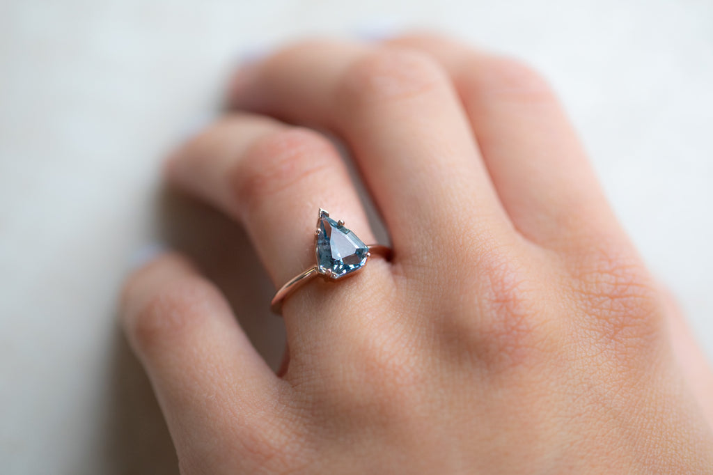 The Bryn Ring with a Shield Cut Sapphire on model