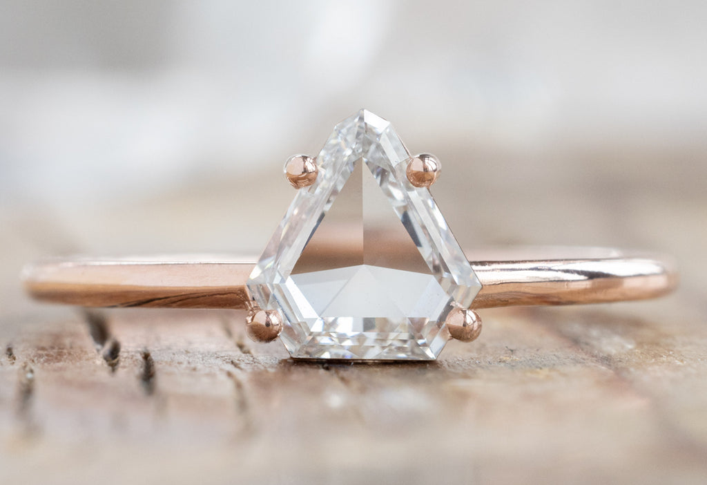 The Bryn Ring with a Geometric White Diamond on Wood Table