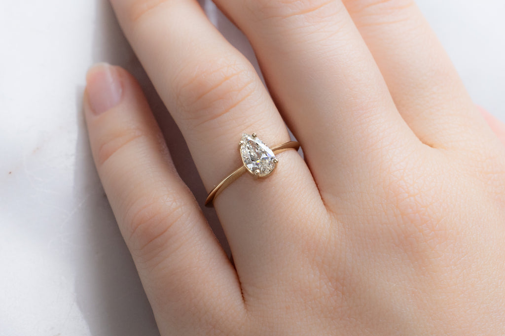 The Bryn Ring with a Pear-Cut White Diamond on Model