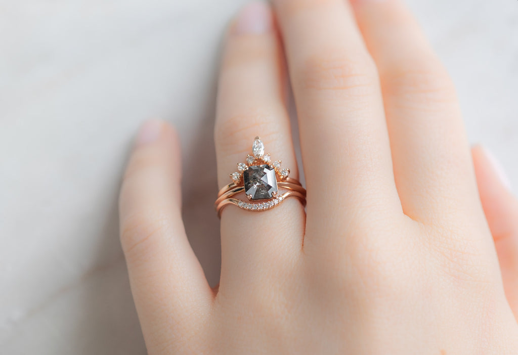 The Bryn Ring with an Emerald-Cut Black Diamond with White Diamond Stacking Bands on Model