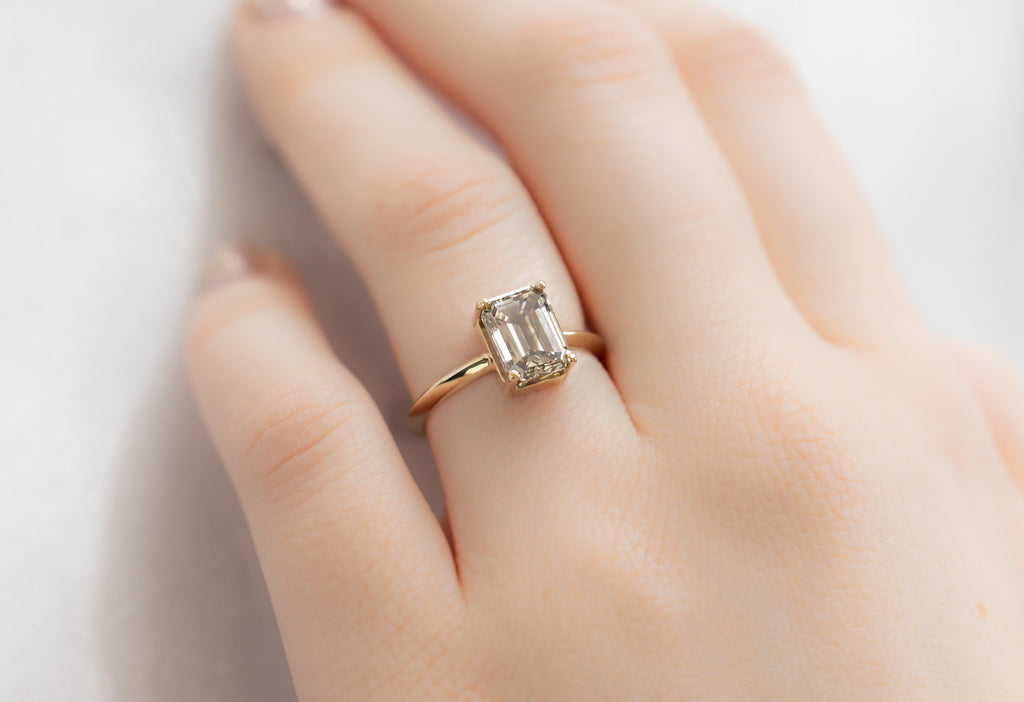 The Bryn Ring with an Emerald-Cut Grey Diamond on Model