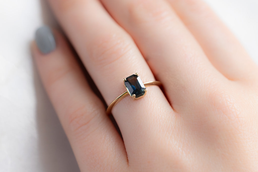 The Bryn Ring with an Emerald-Cut Montana Sapphire on Model