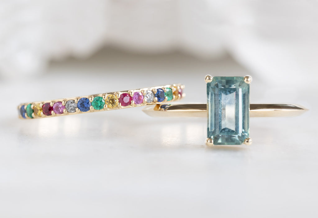 The Bryn Ring with an Emerald-Cut Montana Sapphire with Rainbow Sapphire Stacking Band