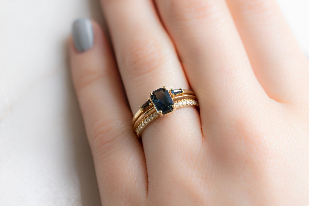 The Bryn Ring with an Emerald-Cut Montana Sapphire with Stacking Band on Model