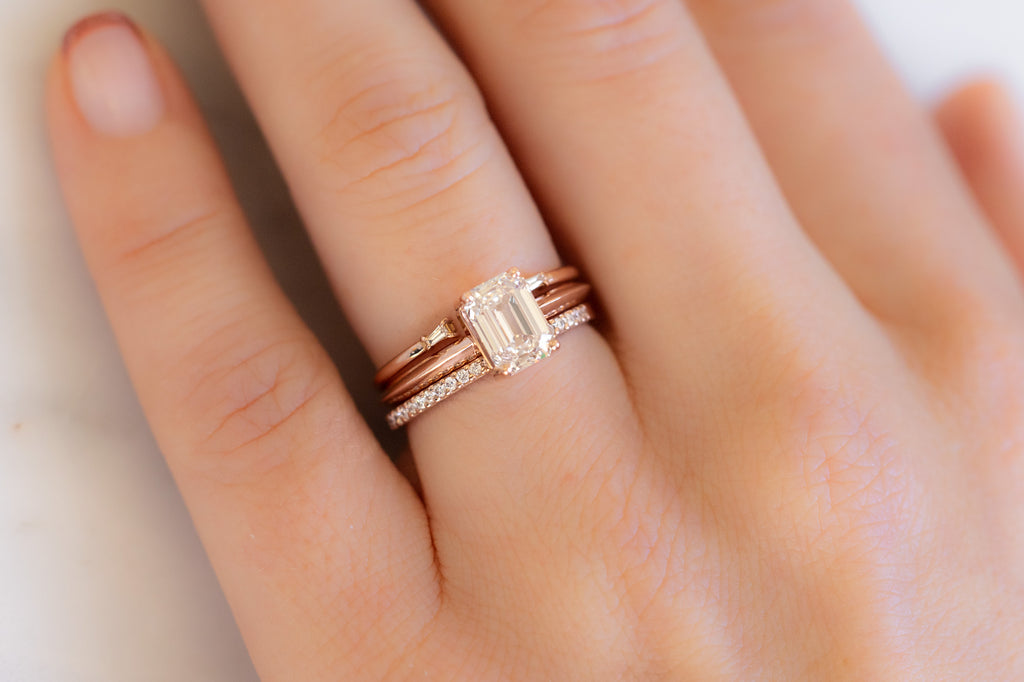 The Bryn Ring with an Emerald-Cut Pink Diamond with Stacking Bands on Model