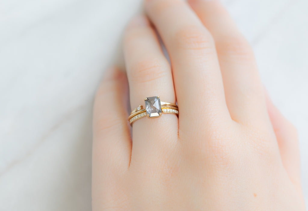 The Bryn Ring with an Emerald-Cut Salt and Pepper Diamond with Stacking Bands on Model