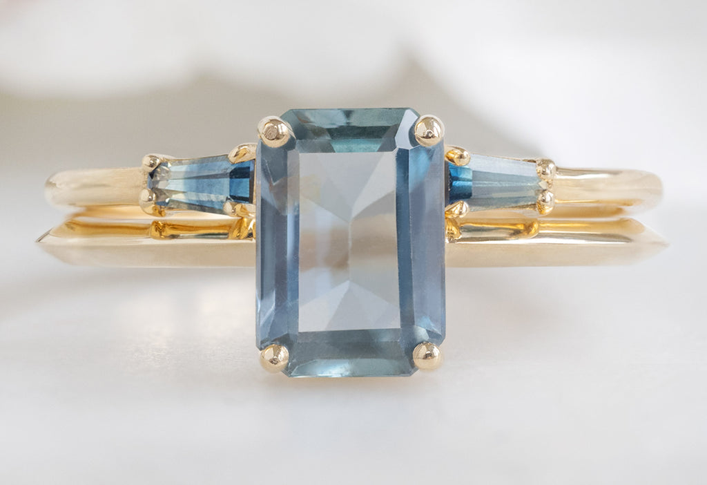 The Bryn Ring with an Emerald-Cut Sapphire with Open Cuff Montana Sapphire Baguette Stacking Band