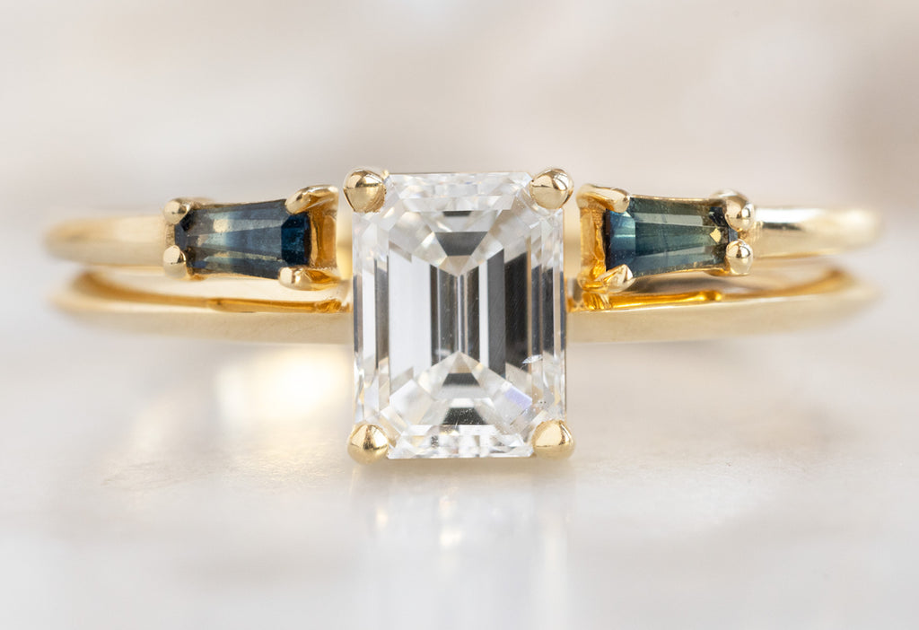 The Bryn Ring with an Emerald-Cut White Diamond with Open Cuff Montana Sapphire Baguette Stacking Band