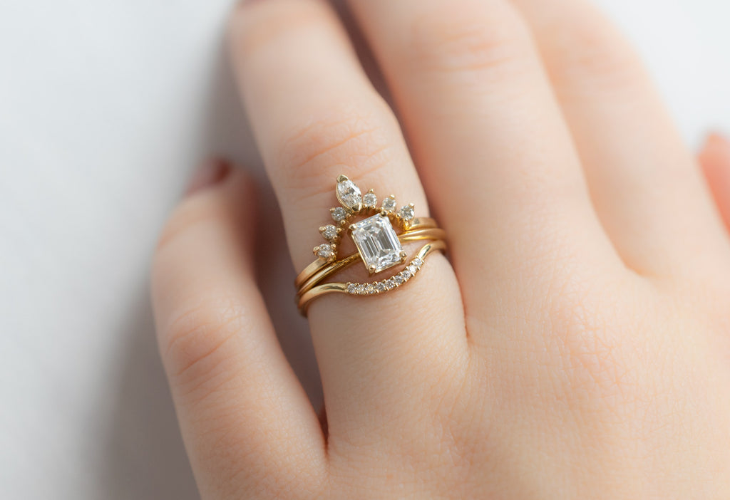 The Bryn Ring with an Emerald-Cut White Diamond with White Diamond Stacking Bands on Model