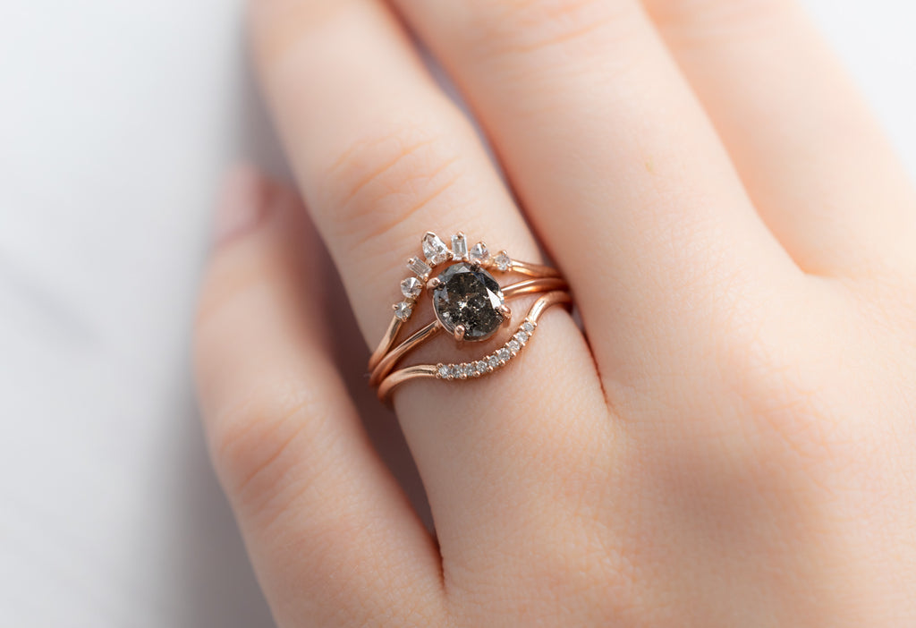 The Bryn Ring with an Oval-Cut Black Diamond with White Diamond Stacking Bands on Model