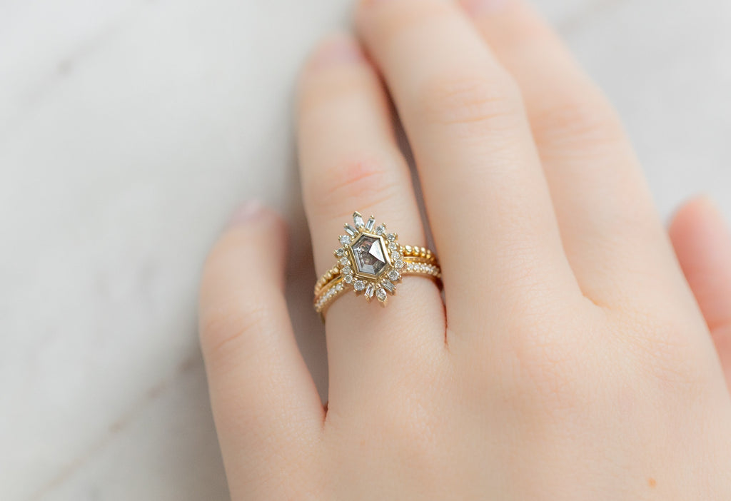 The Camellia Ring with a Salt and Pepper Hexagon Diamond with Stacking Bands on Model