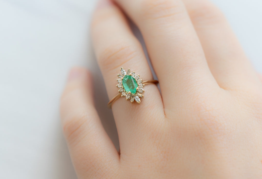 The Camellia Ring with an Emerald Hexagon on Model