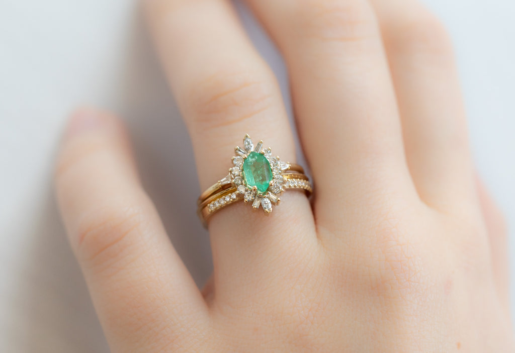 The Camellia Ring with an Emerald Hexagon with Stacking Bands on Model