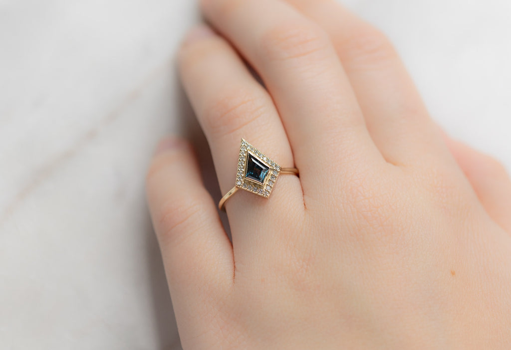 The Dahlia Ring with a Kite-Shaped Montana Sapphire on Model