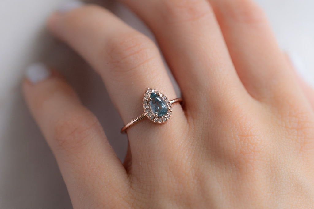 The Dahlia Ring with a Pear Cut Sapphire on Model