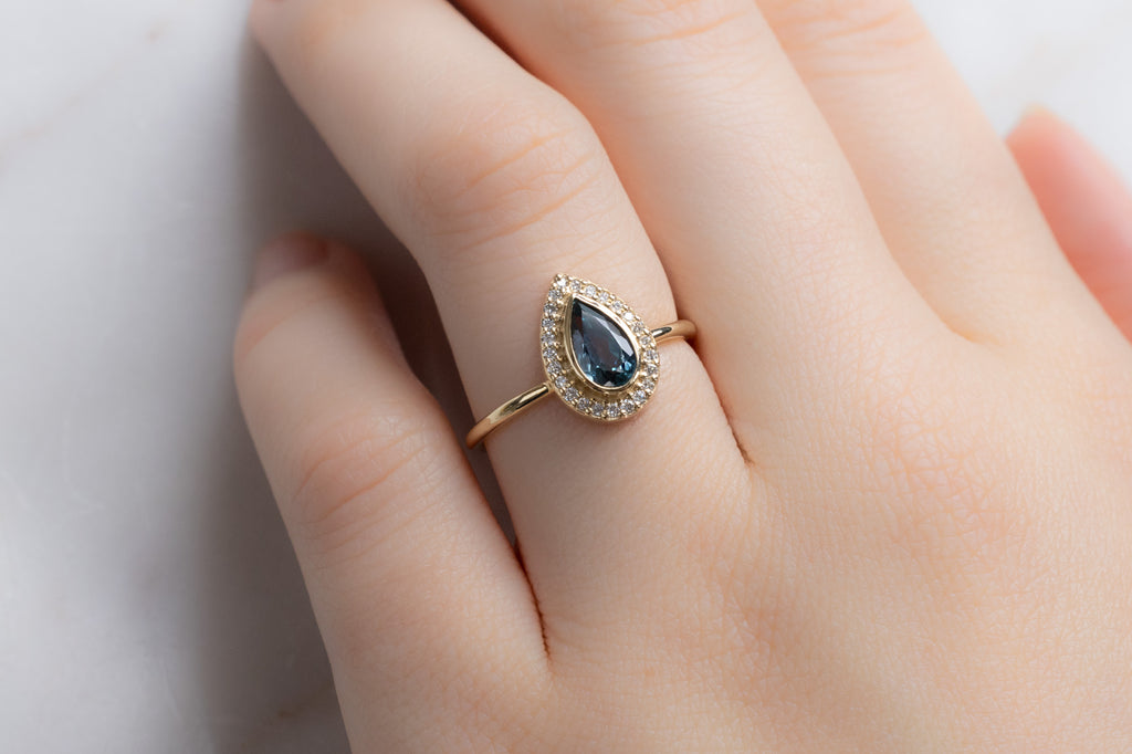 The Dahlia Ring with a Pear-Cut Sapphire on Model