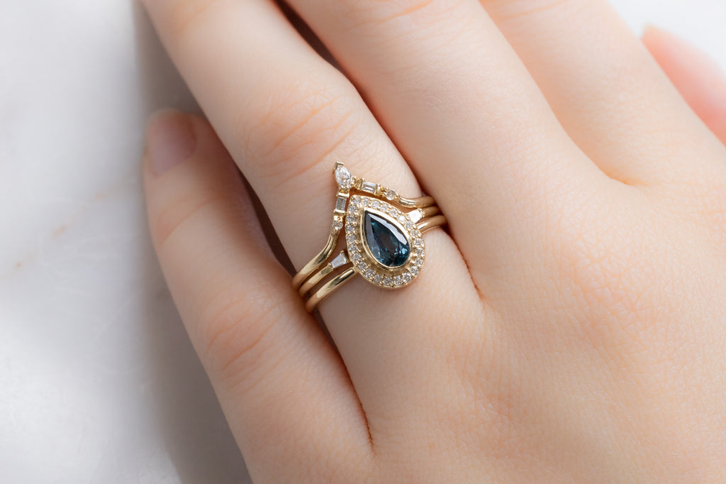 The Dahlia Ring with a Pear-Cut Sapphire with White Diamond Stacking Bands on Model