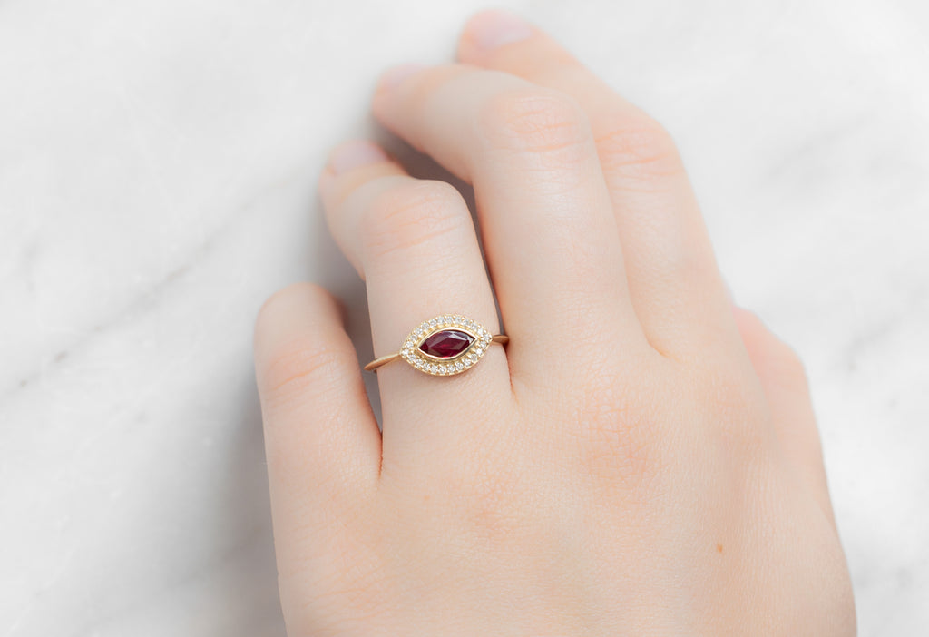 The Dahlia Ring with a Ruby Marquise on Model