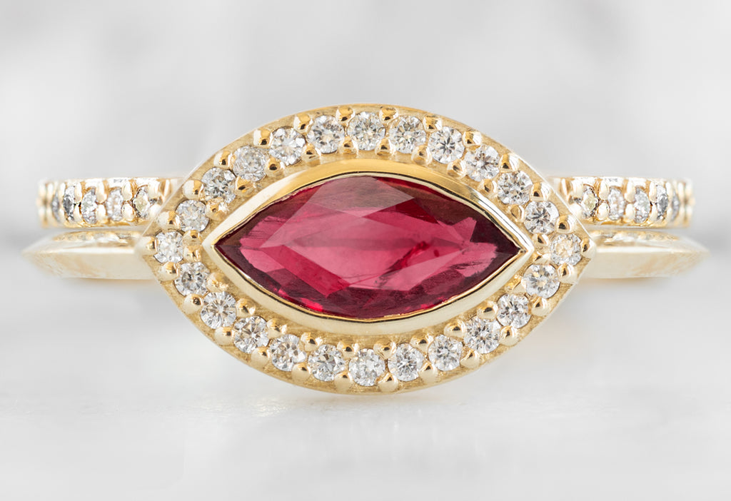The Dahlia Ring with a Ruby Marquise with White Diamond Pave Band