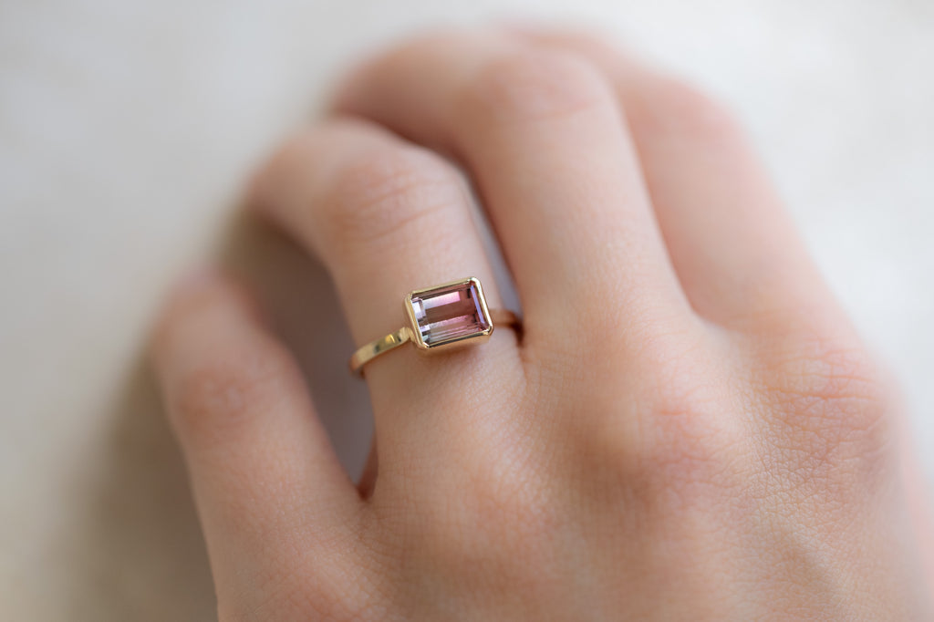 The Hazel Ring with an Emerald-Cut Bi-Color Tourmaline on Model