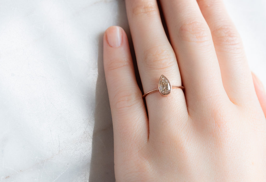 The Hazel Ring with a Pear-Cut Pink Diamond on Model