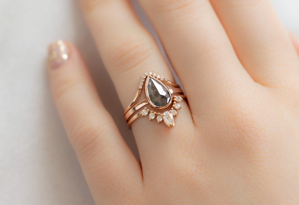 The Hazel Ring with a Rose-Cut Black Diamond with White Diamond Stacking Bands on Model