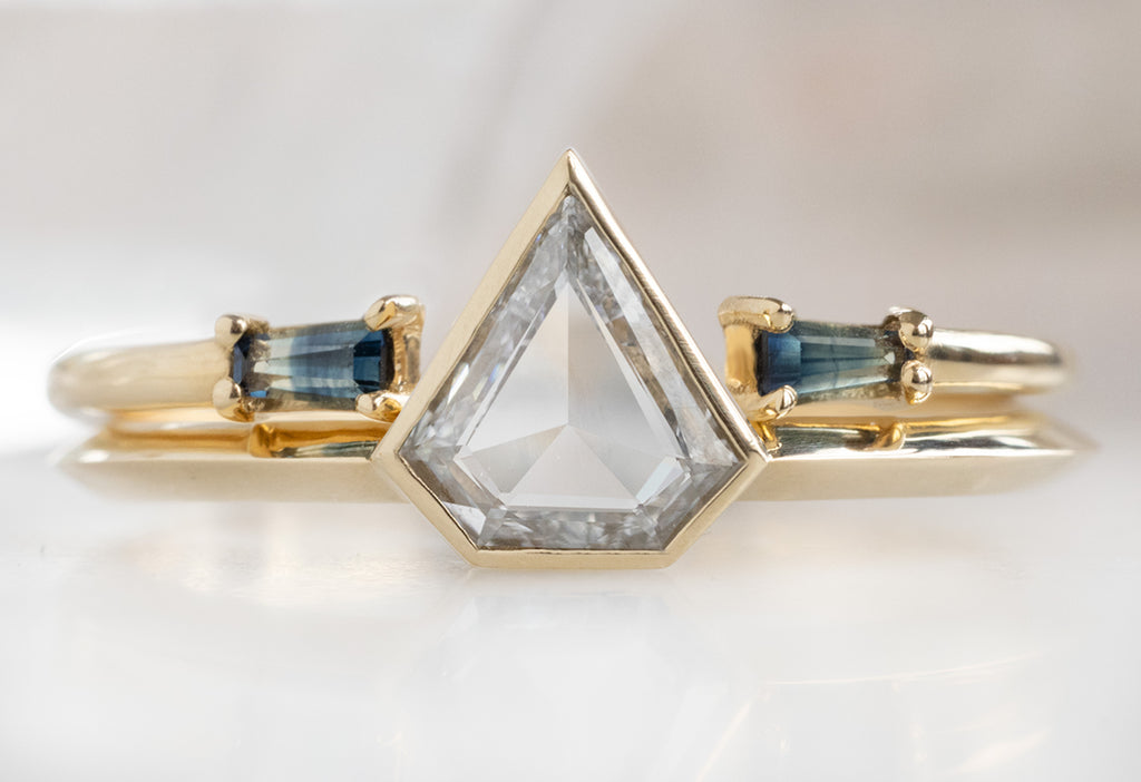 The Hazel Ring with a Shield-Cut White Diamond with Open Cuff Montana Sapphire Baguette Stacking Band