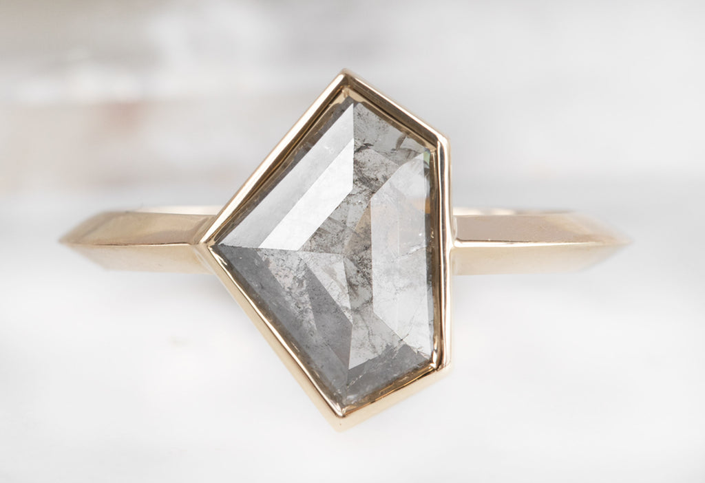 The Hazel Ring with a Silvery-Grey Shield-Cut Diamond