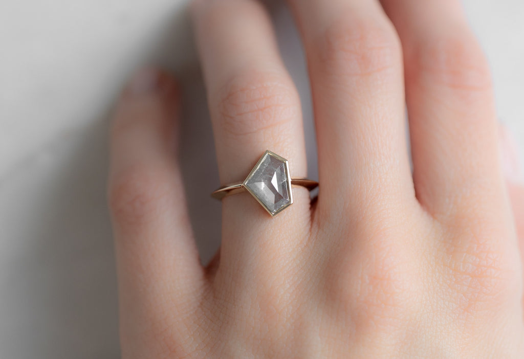 The Hazel Ring with a Silvery-Grey Shield-Cut Diamond on Model