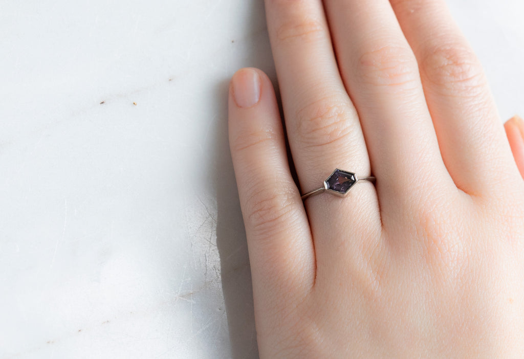 The Hazel Ring with an Artisan-Cut Violet Sapphire on Model