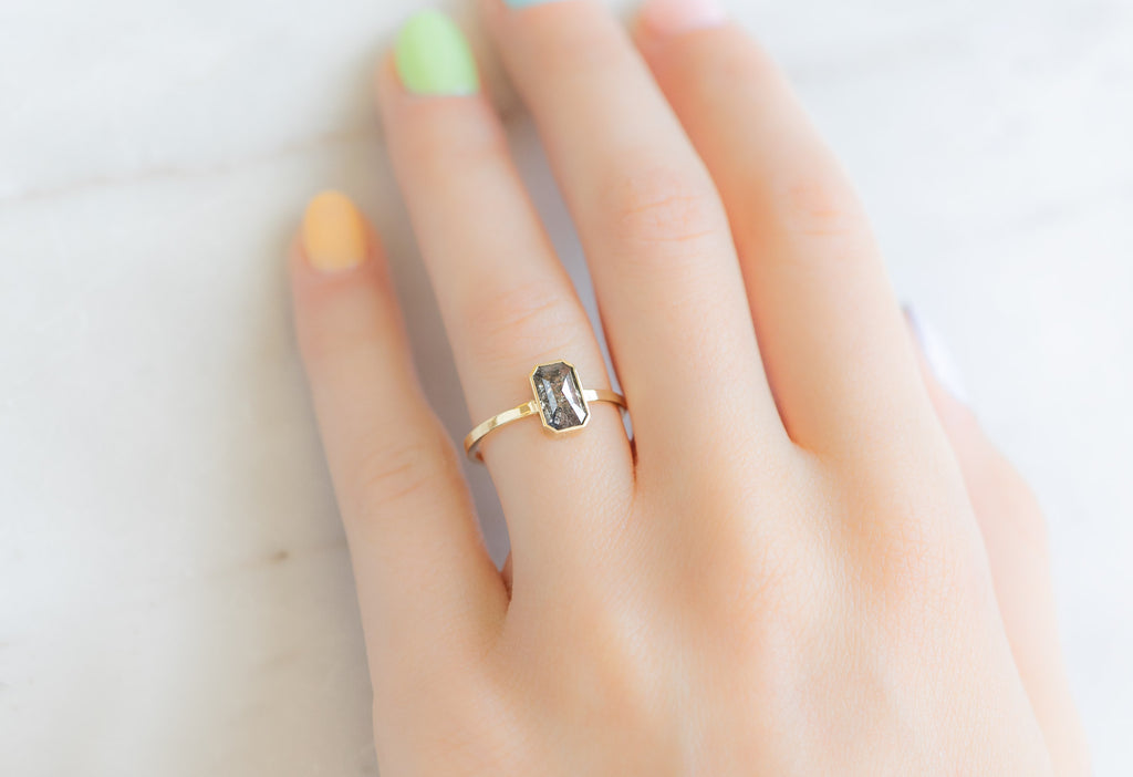 The Hazel Ring with an Emerald-Cut Salt and Pepper Diamond on Model