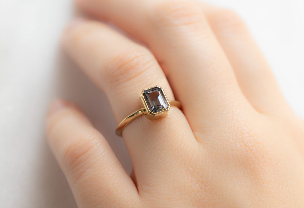The Hazel Ring with an Emerald-Cut Spinel on Model