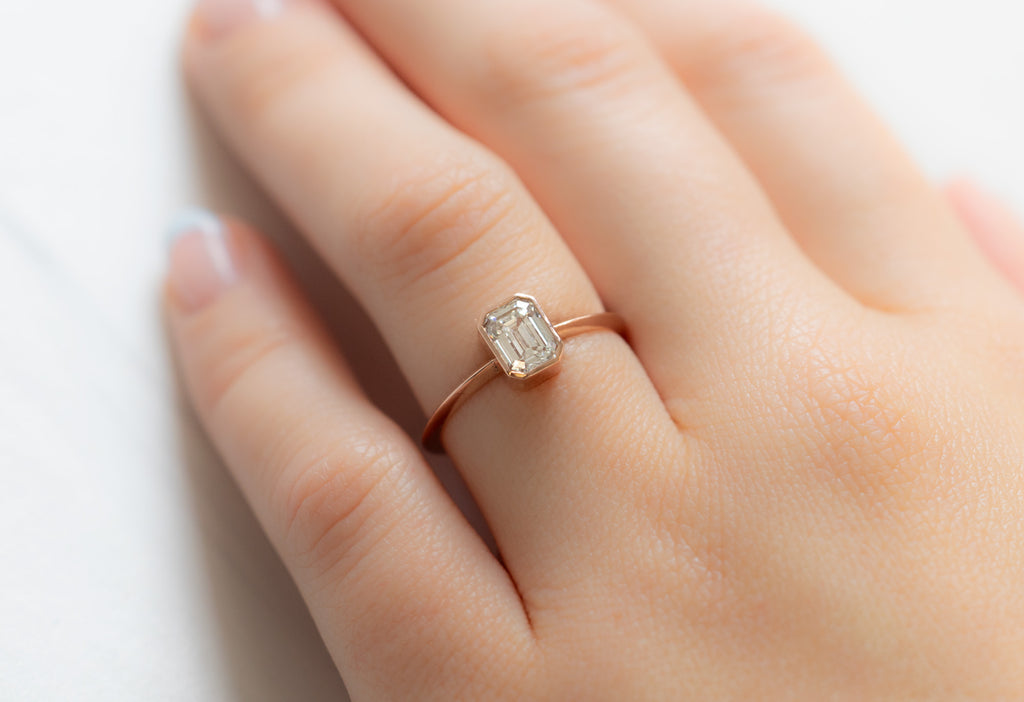 The Hazel Ring with an Emerald-Cut White Diamond on Model