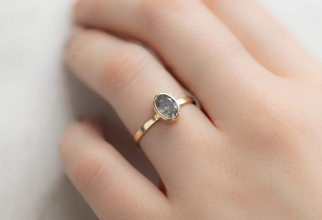 The Hazel Ring with an Oval-Cut Salt and Pepper Diamond on Model