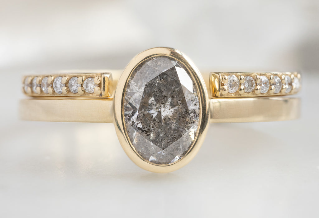 The Hazel Ring with an Oval-Cut Salt and Pepper Diamond with Open Cuff Pavé Stacking Band