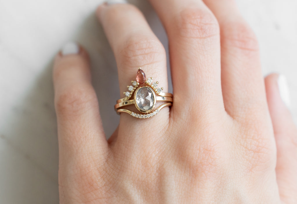 The Hazel Ring with an Oval-Cut Salt and Pepper Diamond with Stacking Bands on Model