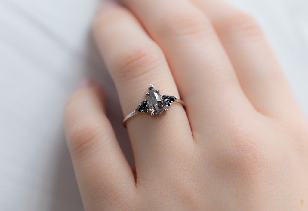 The Ivy Ring with a Black Pear-Shaped Diamond on Model