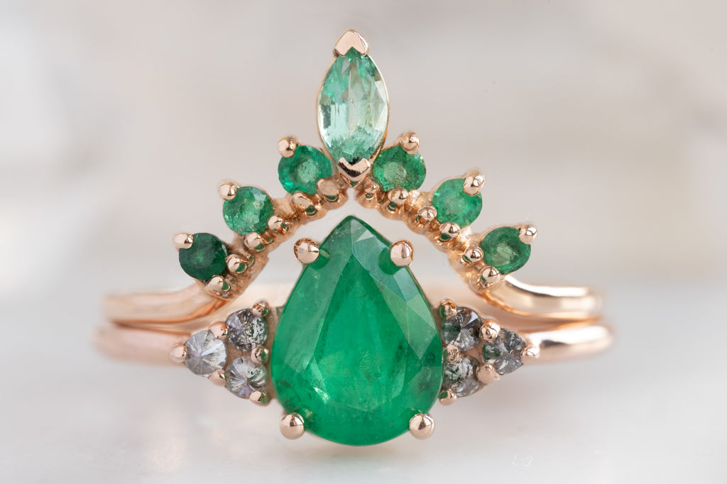 The Ivy Ring with a Pear-Cut Emerald with Emerald Sunburst Stacking Band