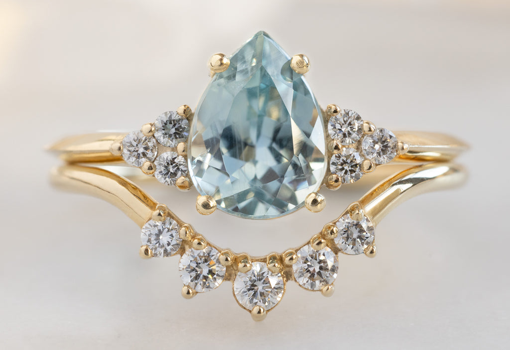 The Ivy Ring with a Pear-Cut Sapphire with Round Diamond Sunburst Stacking Band