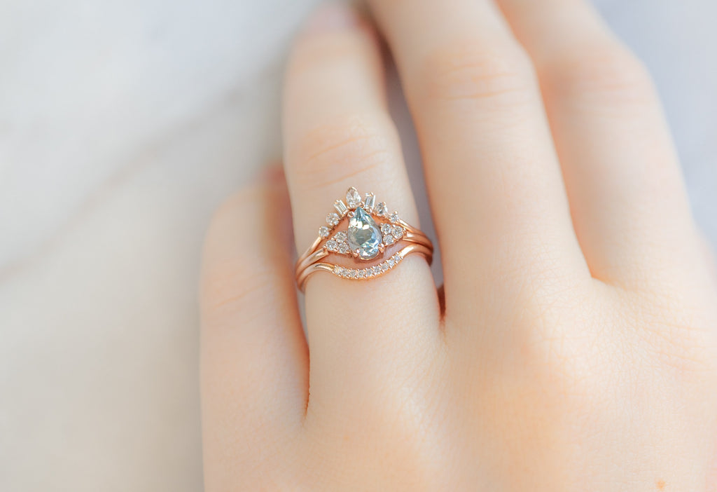The Ivy Ring with a Pear-Cut Sapphire with White Diamond Stacking Bands on Model