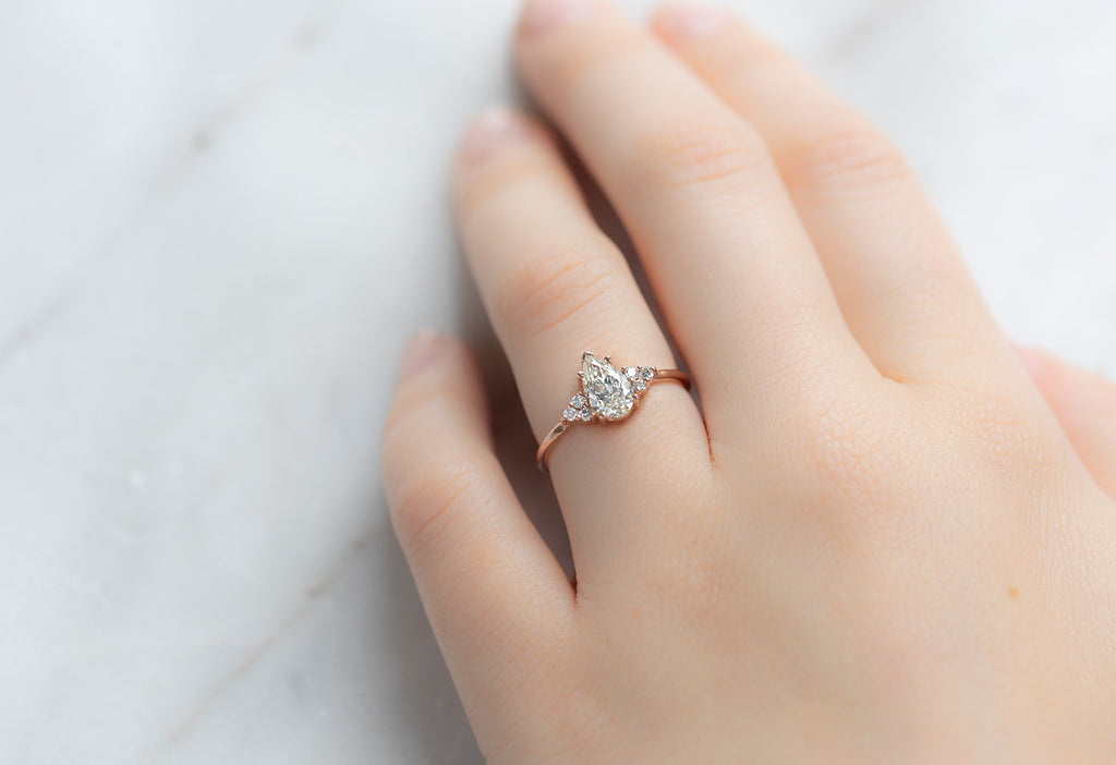 The Ivy Ring with a Pear-Cut White Diamond on Model