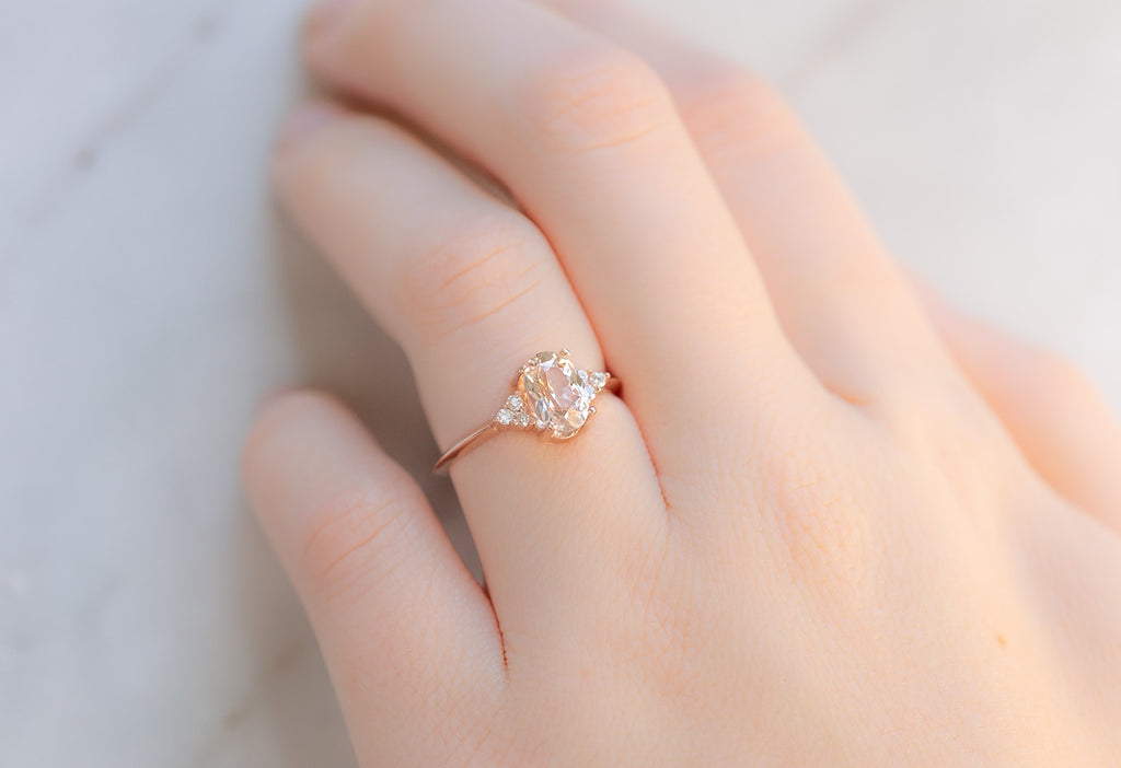 The Ivy Ring with an Oval-Cut Peach Sapphire on Model
