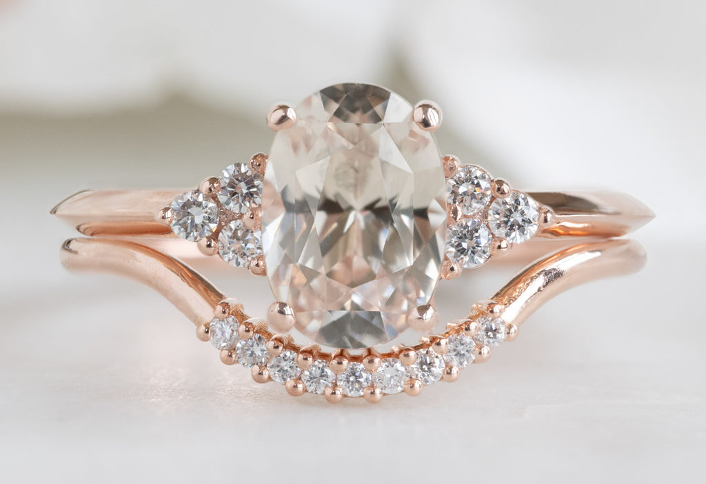 The Ivy Ring with an Oval-Cut Peach Sapphire with Pavé Arc Stacking Band