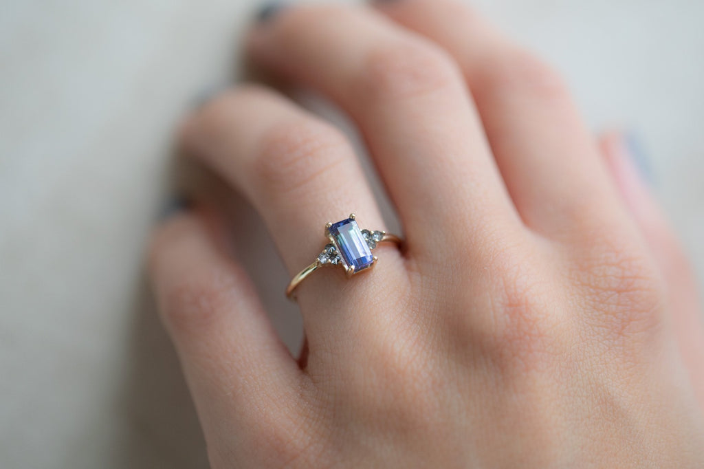 The Ivy Ring with an Emerald Cut Bi-Color Tanzanite on model
