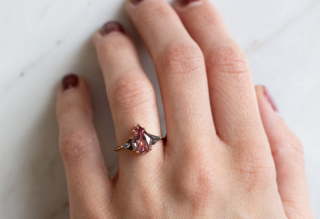 The Jade Ring with a Pear-Cut Malaya Garnet on Model
