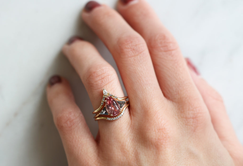 The Jade Ring with a Pear-Cut Malaya Garnet with Stacking Bands on Model