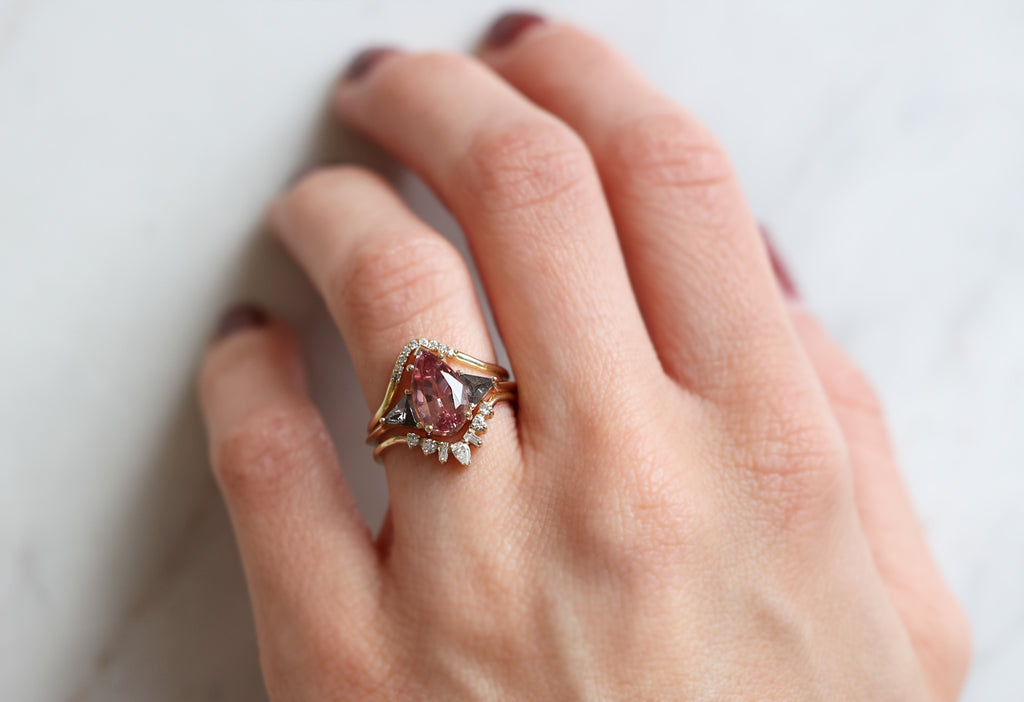 The Jade Ring with a Pear-Cut Malaya Garnet with Stacking Bands on Model